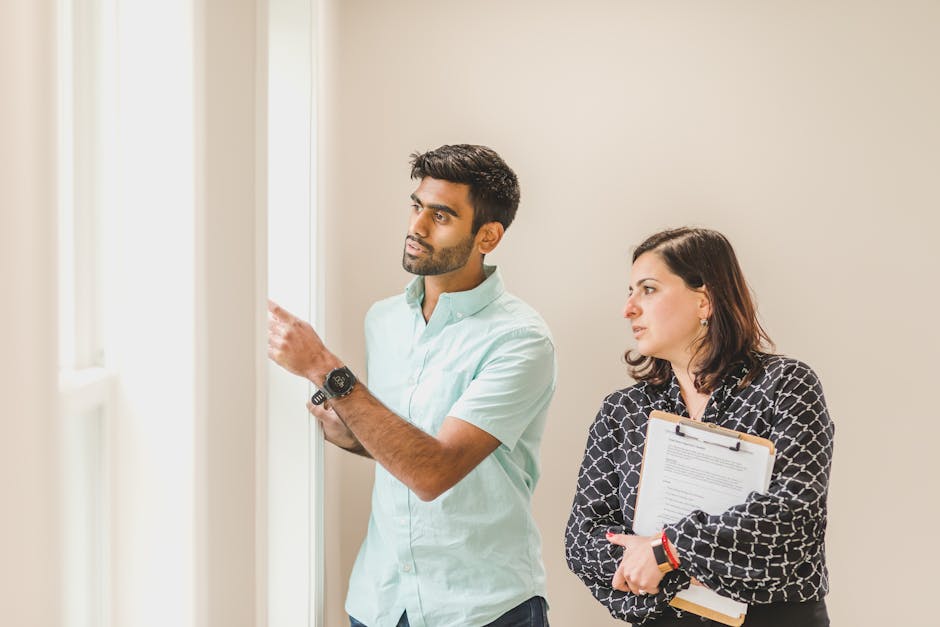 Realtor showing a property to a client indoors, discussing details.